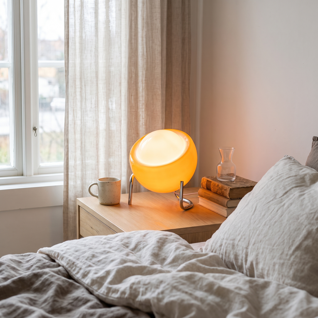 Sienna orange glass table lamp in a Scandinavian interior