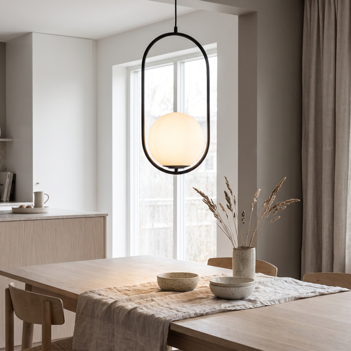 Vessel black and gold glass pendant light in a Scandinavian interior