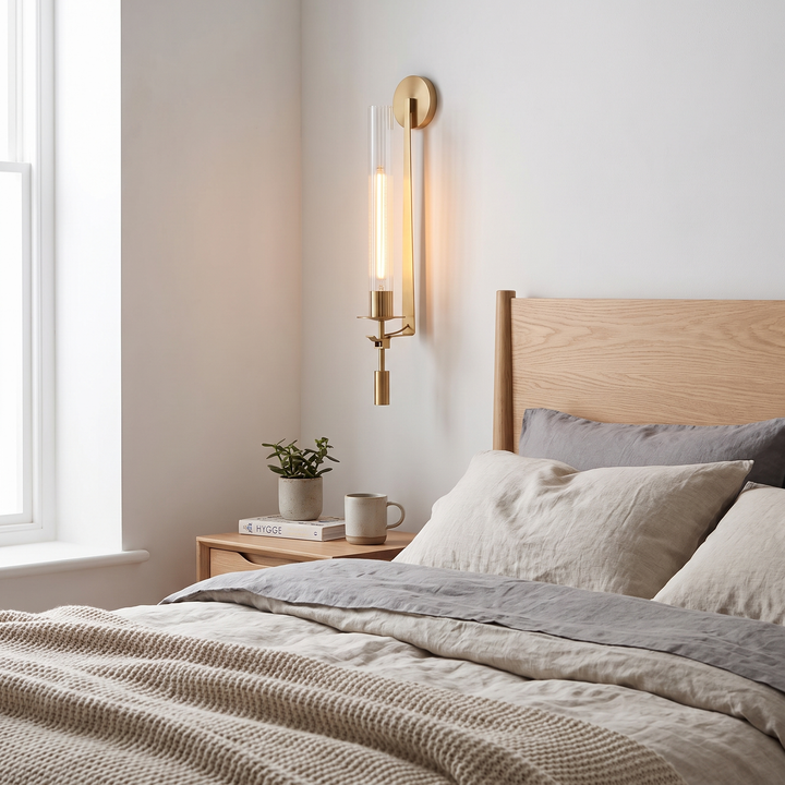 Torch gold wall sconce in a Scandinavian bedroom