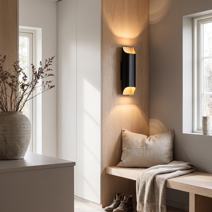 Wedge brass LED wall lamp in a Scandinavian entry hall