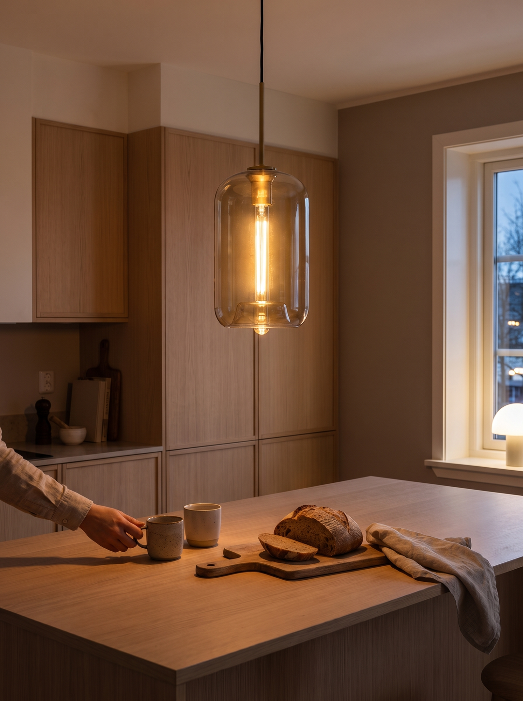 Lumenorth Tumbler Cognac Glass Pendant over a bar counter after dark