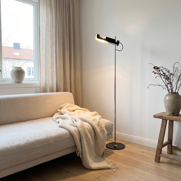 Pivot floor lamp beside a linen sofa in a Scandinavian living room