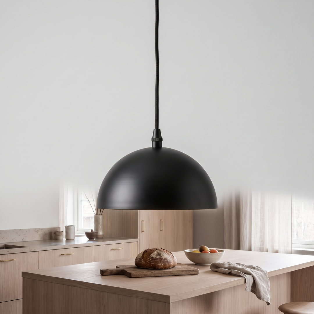 Matte black and opal glass Anvil globe pendant on a light grey background
