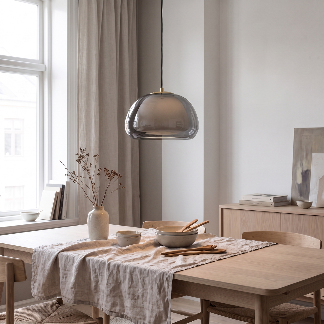 Smoked grey Drop glass globe pendant above an oak dining table